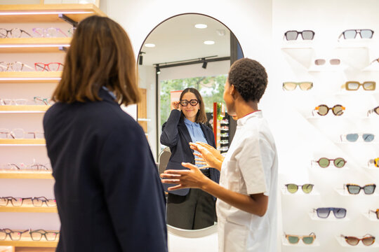 Customer trying on glasses at an optical store