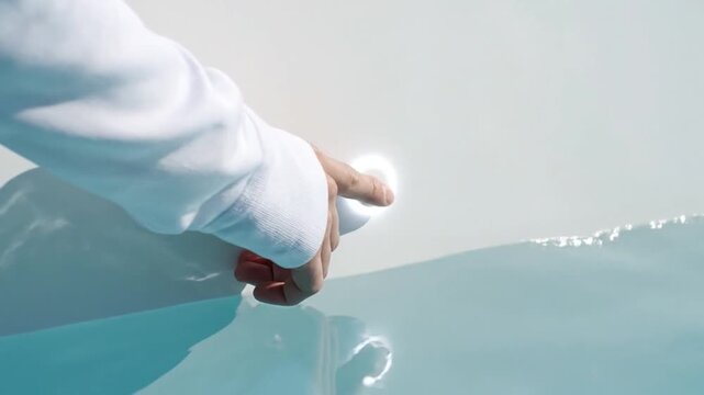Person Touching Water Surface with Finger.