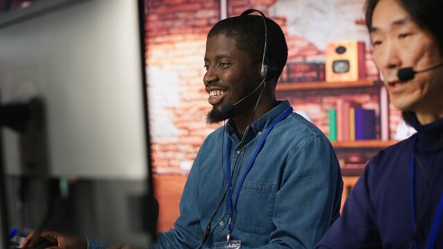 Call center agent helping customers regain access to accounts, diagnosing problems. Customer center staff member assisting clients needing help, providing accurate information, camera A