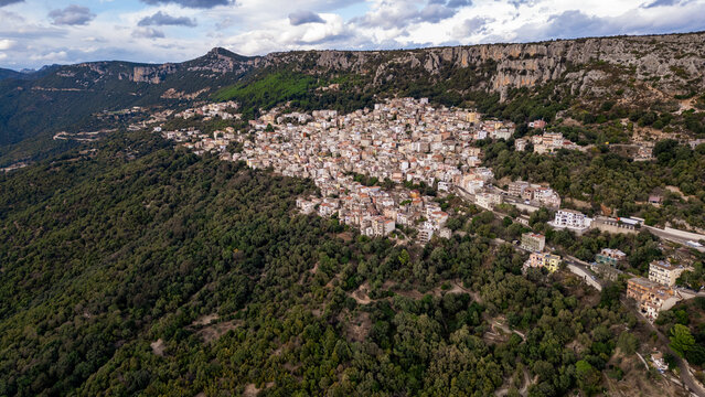 Panoramic view of Baunei village nestled among limestone rocks, Sardinia, Italy.