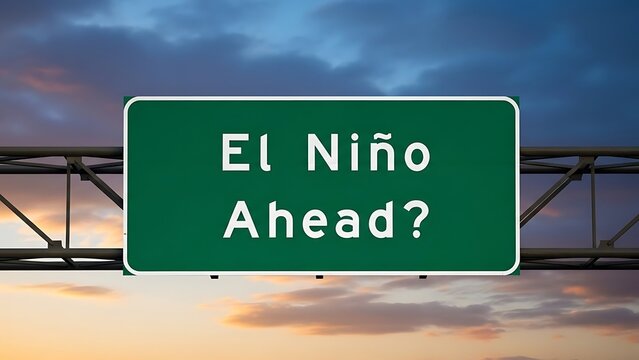 Green road sign with white text El Nino Ahead against sunset sky with metal structure