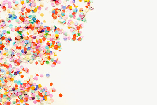 Colored confetti on a white background. New Year's confetti on a white background. Colored background. Texture for text.