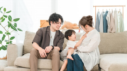 Obraz premium Family relaxing on the sofa at home, family, childcare (affection, family love)