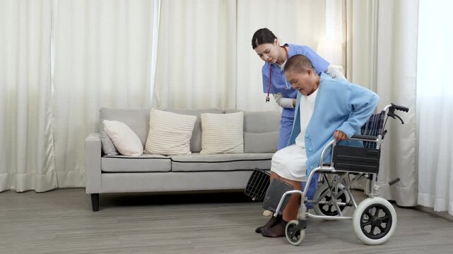 Female caregiver, aged care support helping mature women patient to recover injured leg, physiotherapy, take wheelchair for patient.