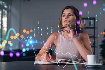 Smiling woman in casual wear taking notes in notebook at office workplace with coffee cup. Concept...