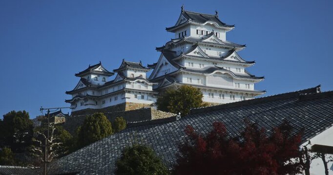 Low, cinematic shot of roof top and majestic 16th century Matsumoto castle