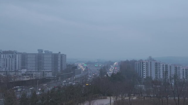 Timelapse of vehicles passing through Moran Tollgate during winter sunrise in Seongnam, South Korea. Early morning traffic flow with changing light conditions.