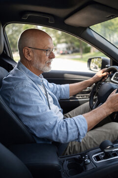 Senior man driving car as independent mobility and active retirement lifestyle concept
