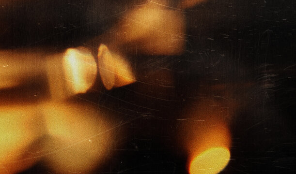 light leak overlay effect with scratch dust and bokeh light leaks, retro grain noisy film distressed texture light leak flare on black background, old film texture