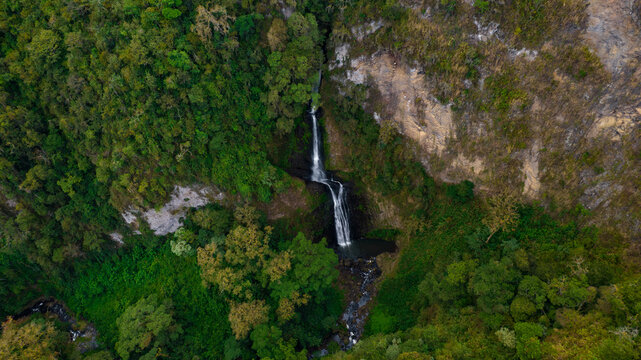 Top Down Aerial View of Tropical Waterfall in Lush Green Forest &ndash; Dramatic Cliff Landscape Drone Photography