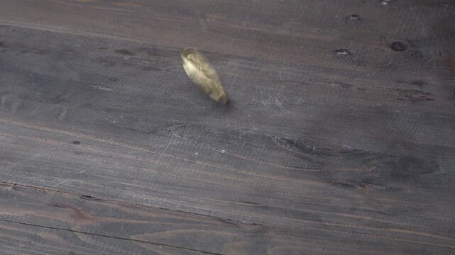 Real coin spun by hand on a wood table