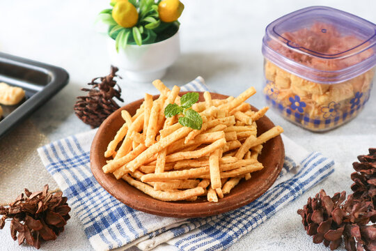 Stik keju, or cheese stick, a savory deep-fried snack made with wheat flour and grated cheese, known for its crispy, crunchy texture.