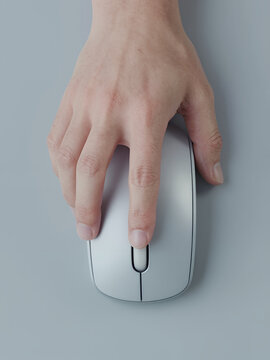 Hand Using A Modern Wireless Silver Computer Mouse On A Plain Background