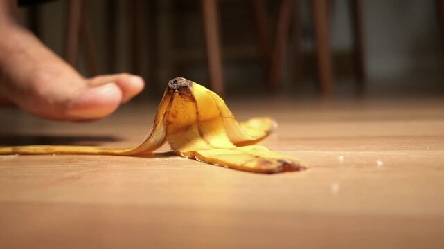 Barefoot Stepping on a Banana Peel on a Wooden Floor
