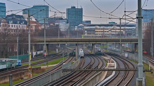 Wide urban shot showing major railway yard infrastructure, multiple active train tracks