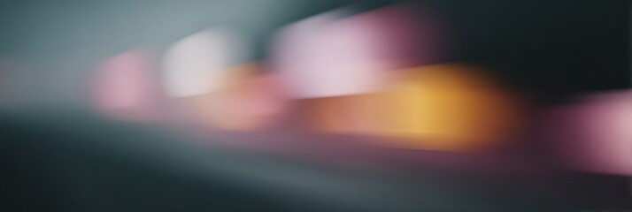 Blurry image of a city street with a mix of pink, yellow, and orange lights