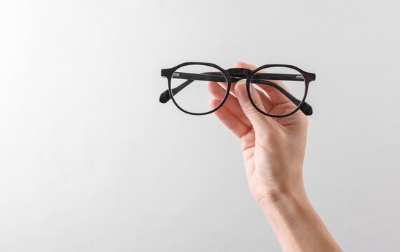 Classic Eyeglasses in hand on a white background