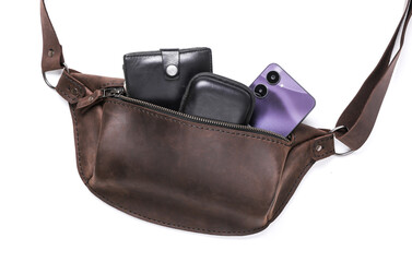 Leather belt bags with purse, smartphone on a white background © splitov27