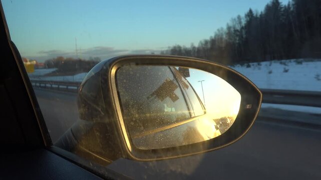 Stockholm, Sweden A sunset view of the E4 highway in a car side mirror 