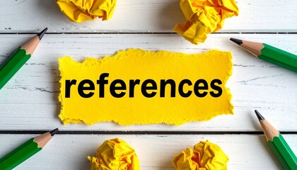 Torn yellow paper with "references" text and pencils