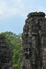 Fototapeta premium Stone carving on the walls of ancient Khmer buddhist temples in the Siem Reap area of Cambodia 