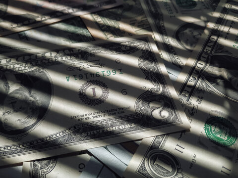 The horizontal shadow of the blinds resembles the grid on dollar bills. The concept of prison, punishment for money laundering, theft, crime and tax evasion. Corruption and counterfeiting.