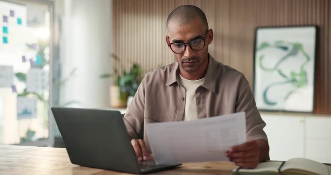 Business, man and laptop with document in office for research, editing article and proofreading. Male person, pc and interview paperwork for story manuscript, copywriting report and editor feedback
