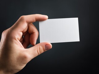 Obraz premium hand holding blank card isolated on a black background