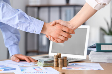 Business partners shaking hands in  office, closeup