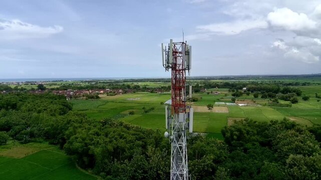 Aerial view of a Base Transceiver Station (BTS) tower or telecommunication tower from close range.