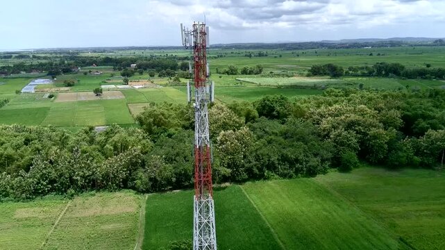 Aerial view of a Base Transceiver Station (BTS) tower or telecommunication tower from close range.