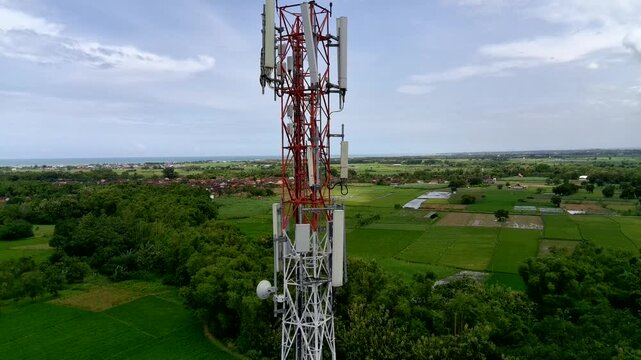 Aerial view of a Base Transceiver Station (BTS) tower or telecommunication tower from close range.