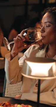 Restaurant, cheers and couple with wine on date for bonding, romantic evening and connection. Happy, fine dining and man with woman with alcohol for valentines day, conversation and toast for love