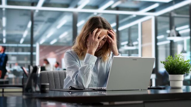 Frustrated Older Woman Employee At Desk