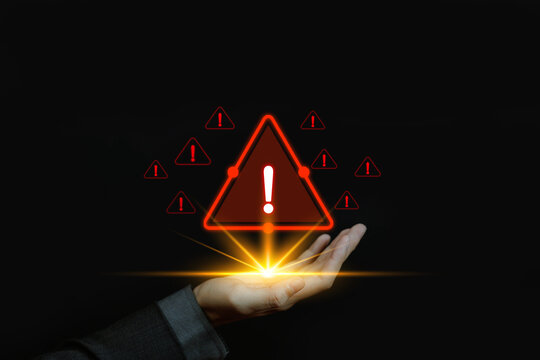 High risk alert concept, glowing red warning icon above businessman hand, crisis management and security threat notification, digital danger signal, business risk control and emergency response.
