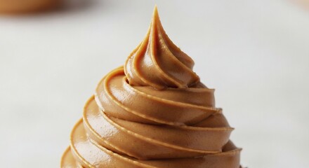 Swirl of Caramel Decadent closeup of glossy swirl with white backdrop.