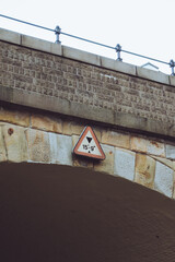 A warning sign on a low bridge showing the maximum height allowed for vehicles 