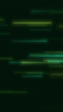 Green and yellow light streaks and particles drifting across a dark field