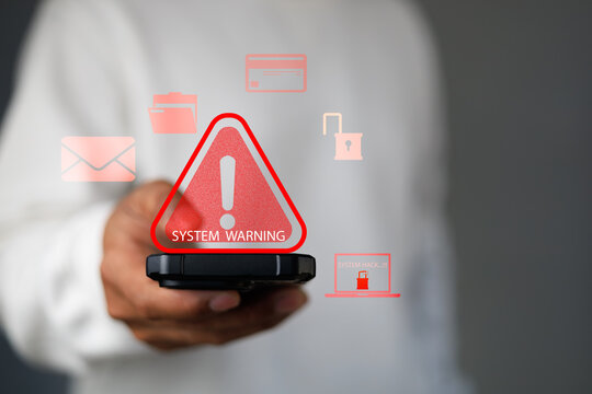 System warning alert on smartphone screen symbolizing cybersecurity threat,hacking attack, data breach risk,digital security protection for online business,network systems,personal data privacy.