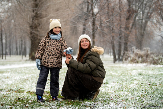 Two girls playing in fresh snow.  activity in winter park