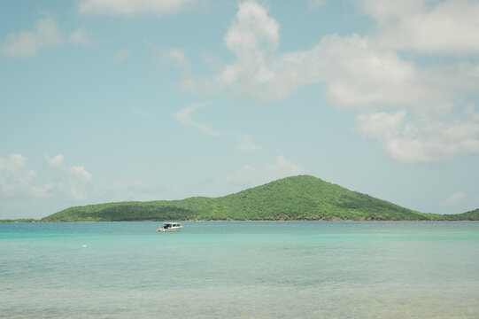 Small boat floats on turquoise water at Playa Sardinas, Culebra