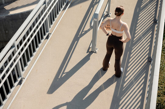 Fitness Woman in Athletic Wear on Bridge