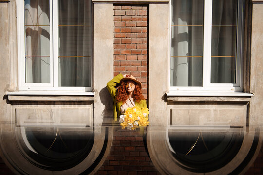 Woman with Flowers in Window