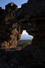 Fototapeta premium Mountain through a hole in rocks