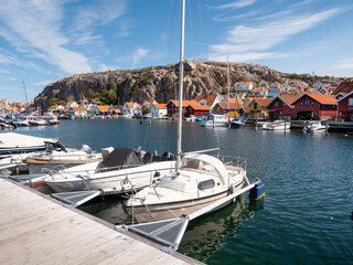 Pleasure boats moored at marina with historic old town and Vetteberget in Fjällbacka, Bohuslän, west coast Sweden © TasfotoNL