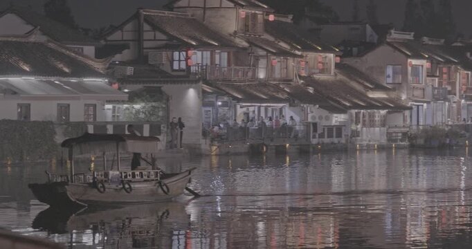 Scenic riverside view with traditional architecture and lanterns at night. Zhujiajiao, Shanghai, China