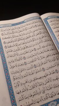 Reading Open Quran Pages Close Up Islamic Holy Book in Ramadan. Vertical video.