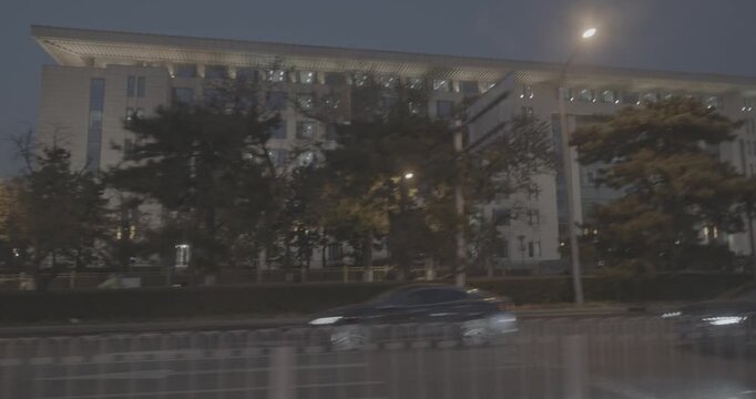 Cityscape at Dusk with Bus in Motion and Night Lights