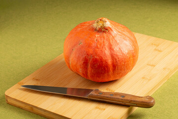 Orange pumpkin on a cutboard