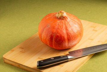 Orange pumpkin on a cutboard